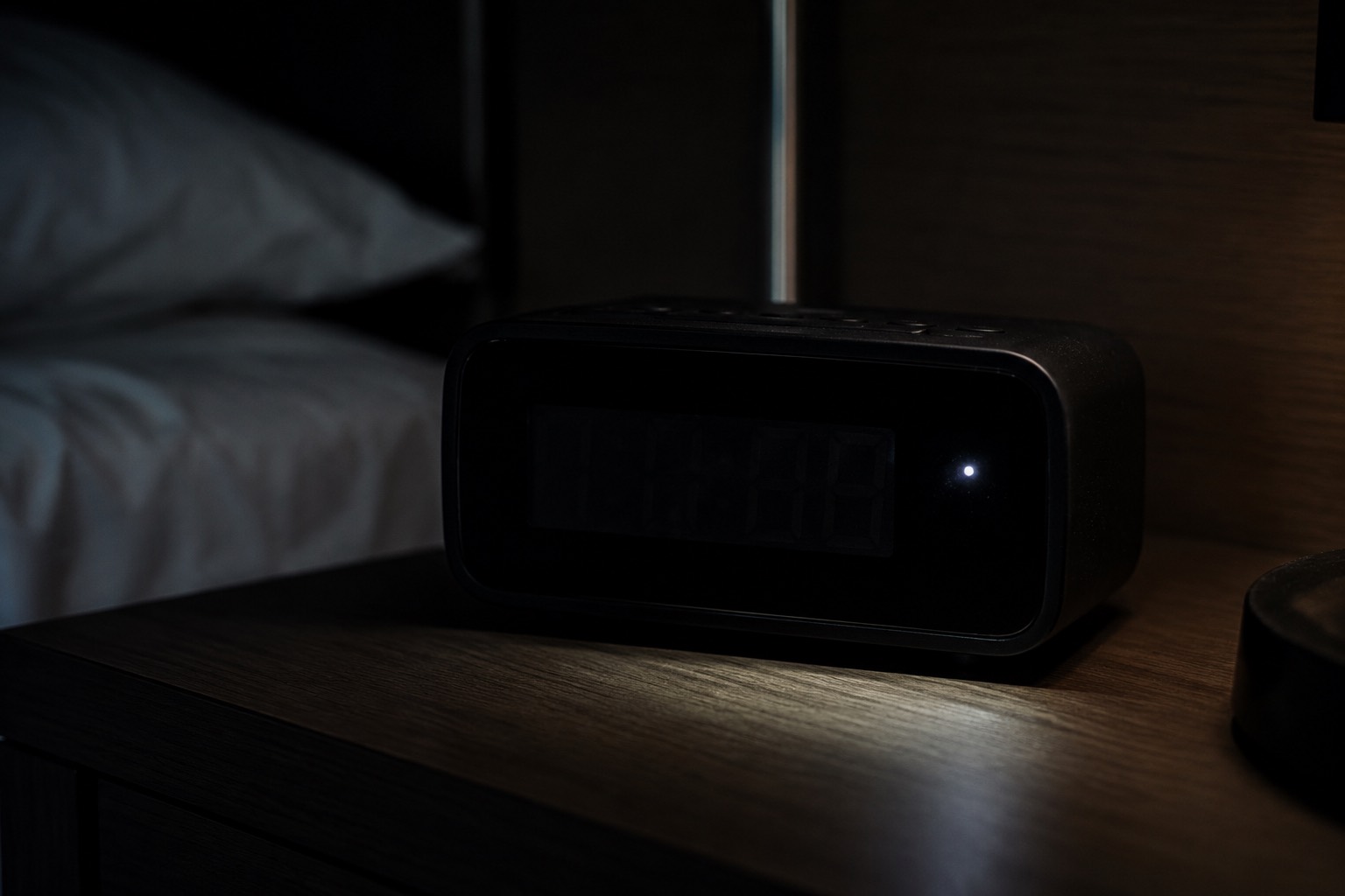 Using a phone flashlight to detect a hidden camera lens reflection